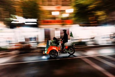 a man riding a motorcycle down a city street