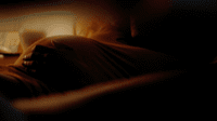 a blurry image of a person laying in bed