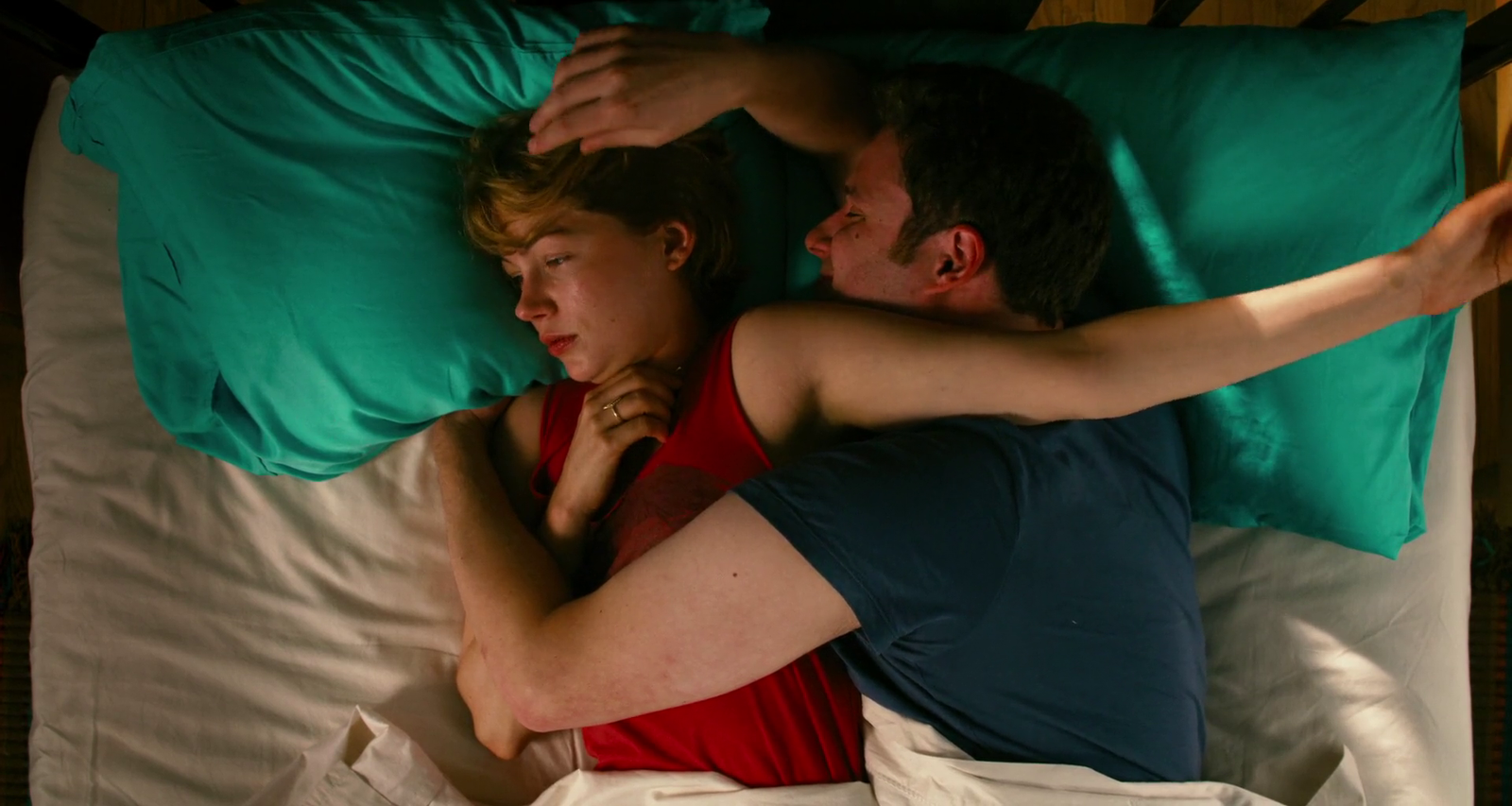 a man and a woman laying in bed together