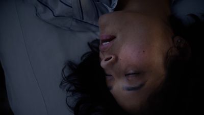 a woman laying in bed with her eyes closed