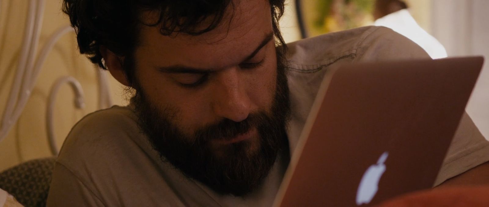 a man with a beard using a laptop computer