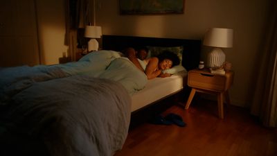 a woman laying on a bed in a bedroom