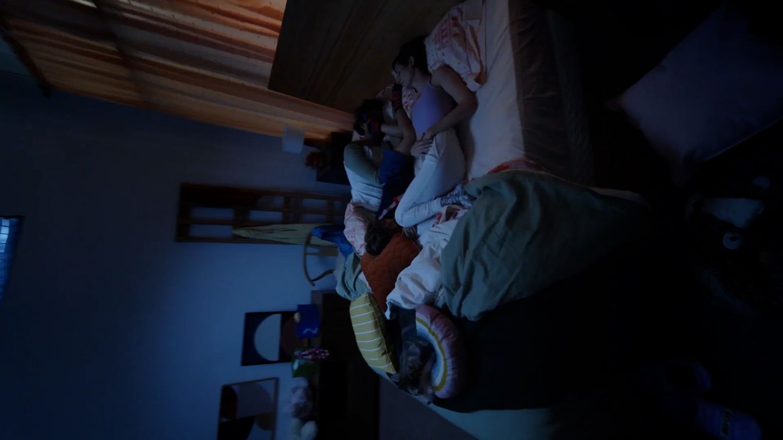 a group of people sleeping on top of a bed