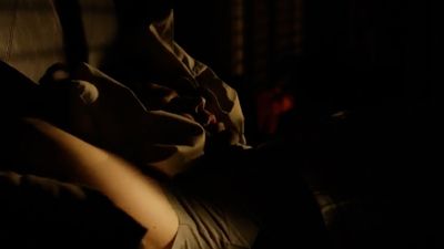 a person laying down in a dark room