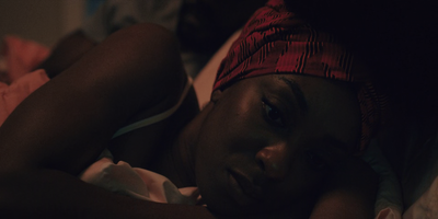 a woman laying in bed with a red headband