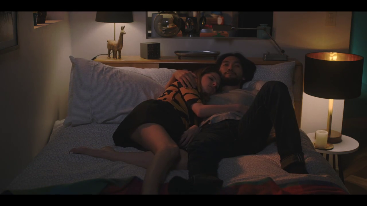 a man and a woman laying on a bed