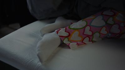 a stuffed animal laying on top of a bed