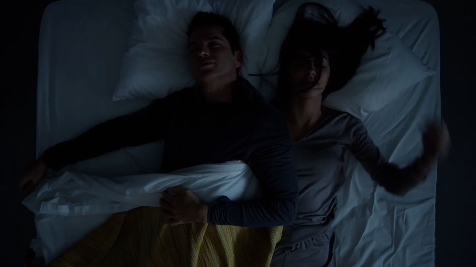 a man and a woman laying in bed together