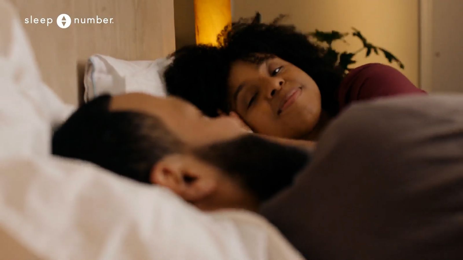 a man and a woman laying in a bed