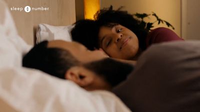 a man and a woman laying in a bed