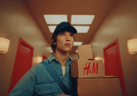 a man holding a box in a hallway