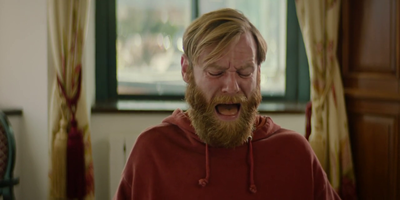 a man with a beard and a red hoodie