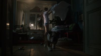 a man and a dog in a dark room