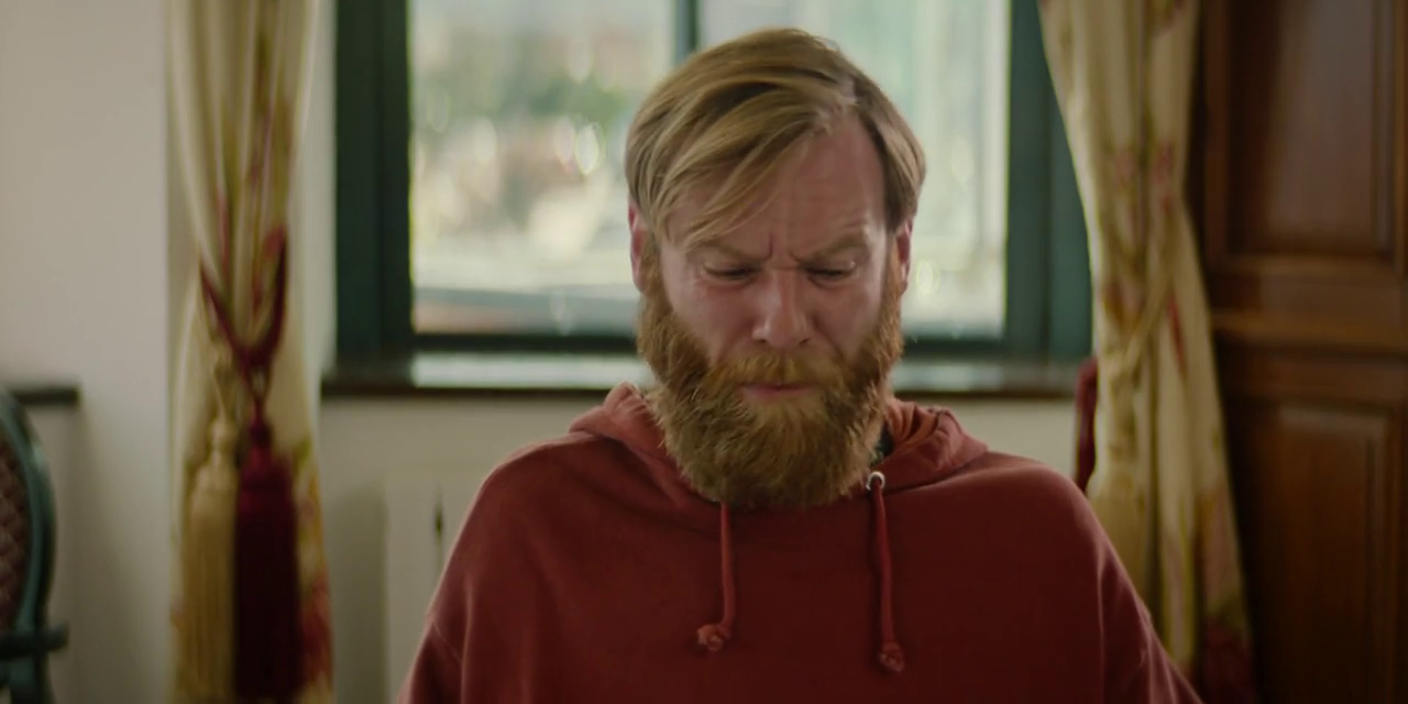 a man with a beard wearing a red hoodie