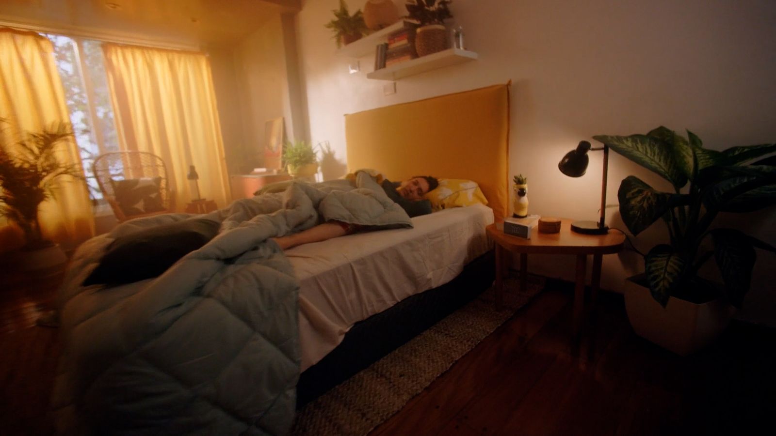 a person laying on a bed in a room