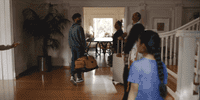 a group of people standing in a living room