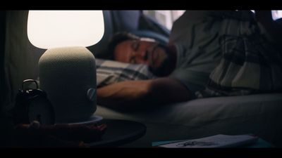 a man laying on a couch next to a lamp