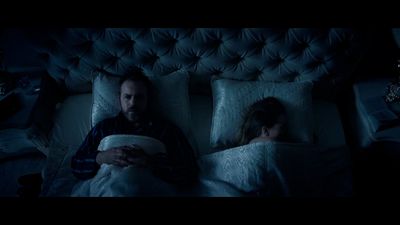 a man and a woman laying in bed together