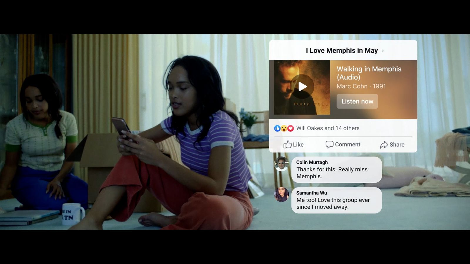 a woman sitting on the floor looking at her cell phone