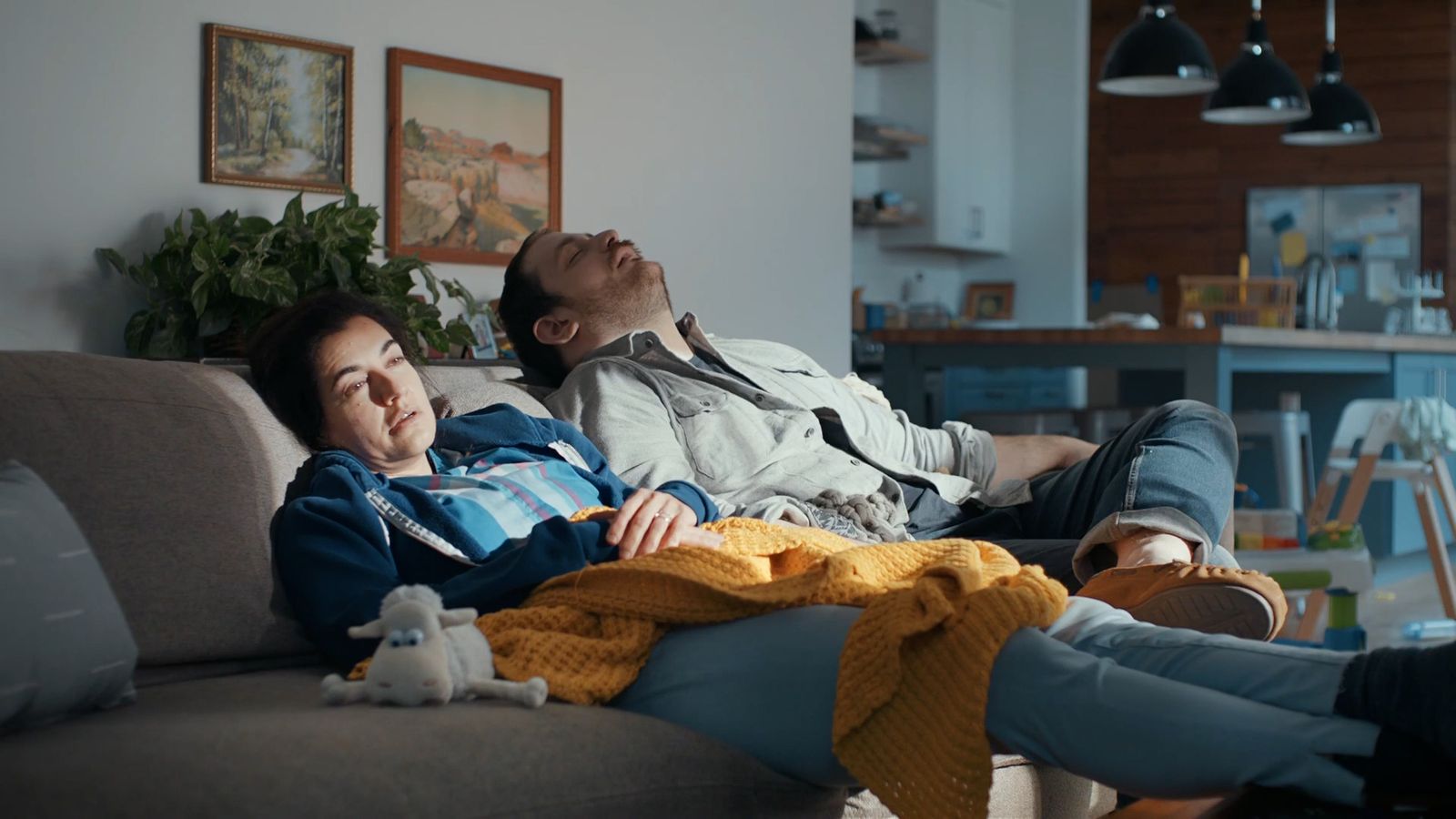 a man and a woman laying on a couch