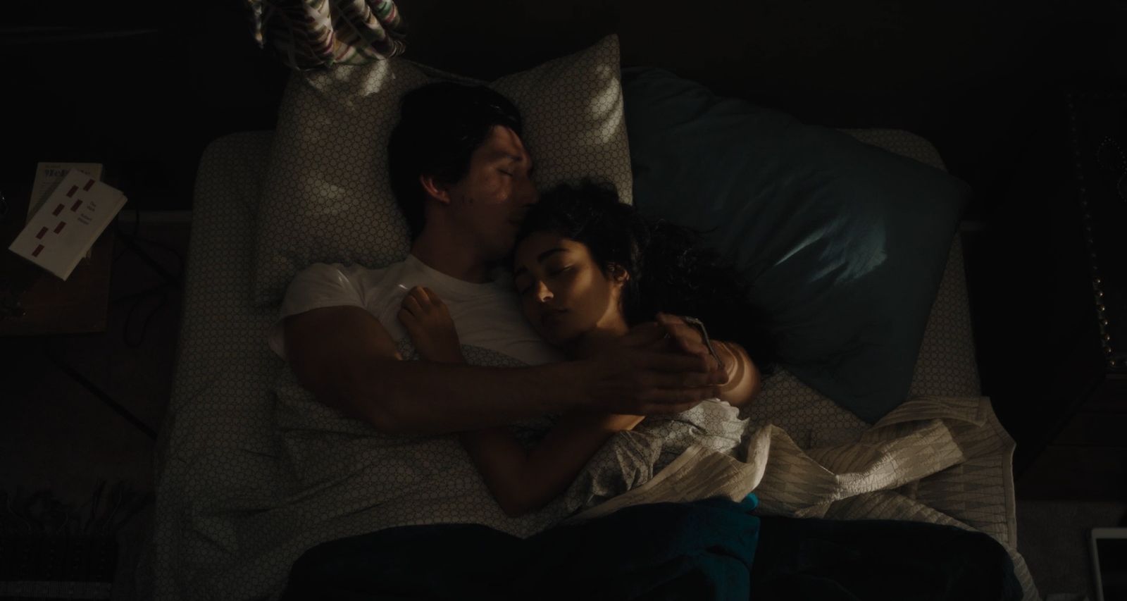 a man and a woman laying on a bed together