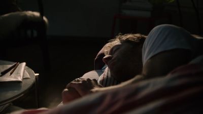 a couple of people laying in bed next to each other