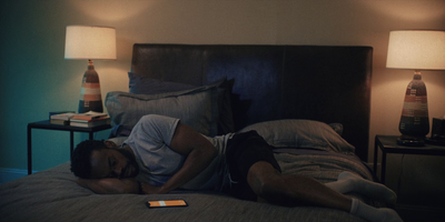 a man laying on a bed in a bedroom