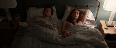 a man and a woman laying in a bed