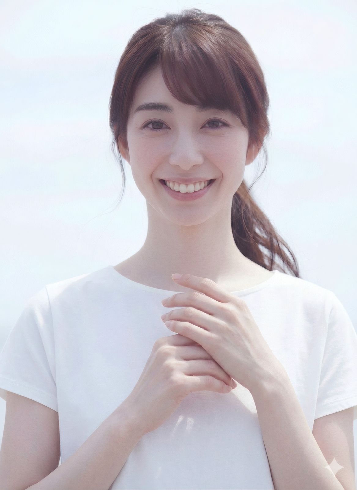 a woman smiling and holding her hands together