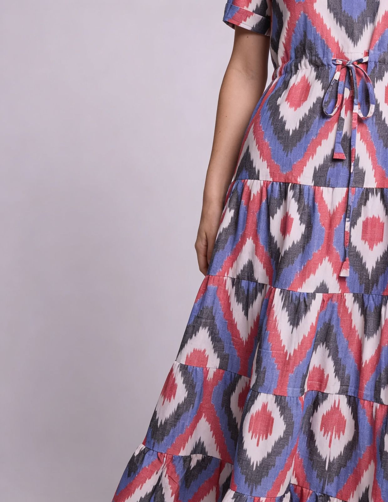 a woman wearing a dress with a red, white and blue pattern