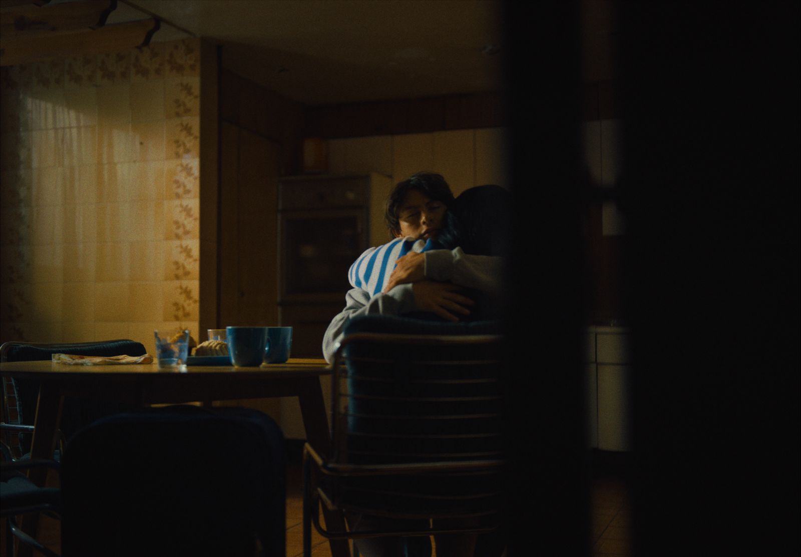 a man sitting at a table in a dark room