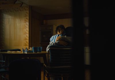 a man sitting at a table in a dark room