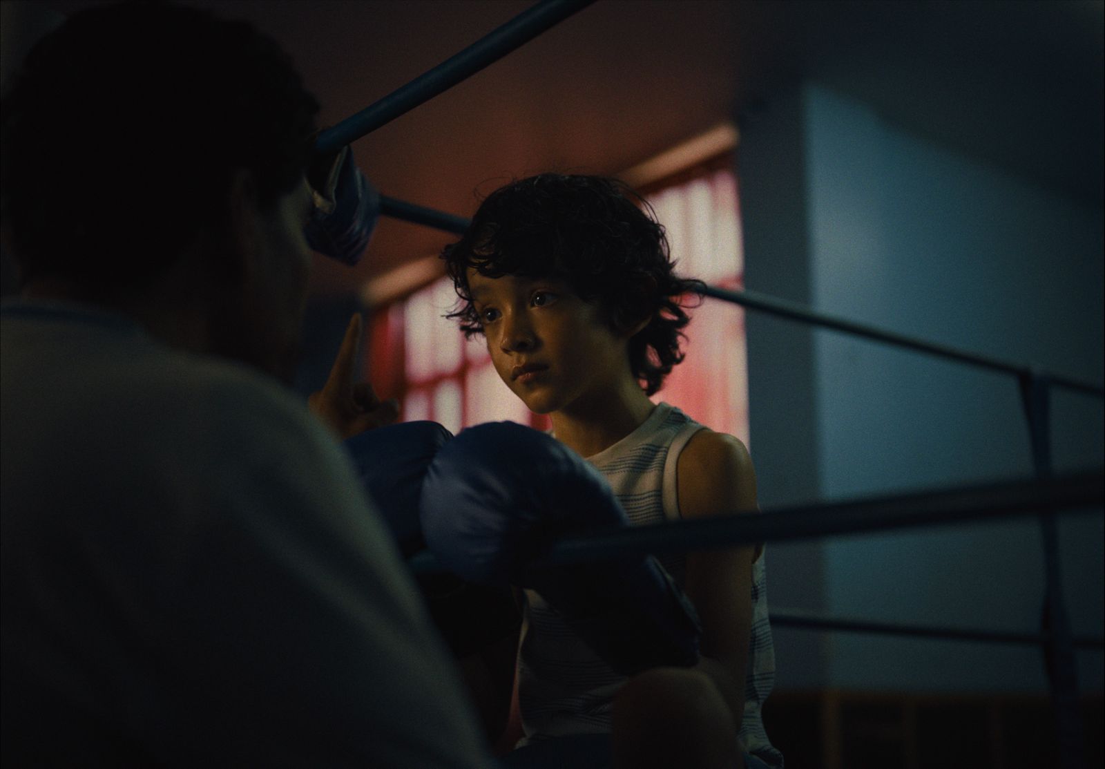 a woman sitting next to a man in a boxing ring