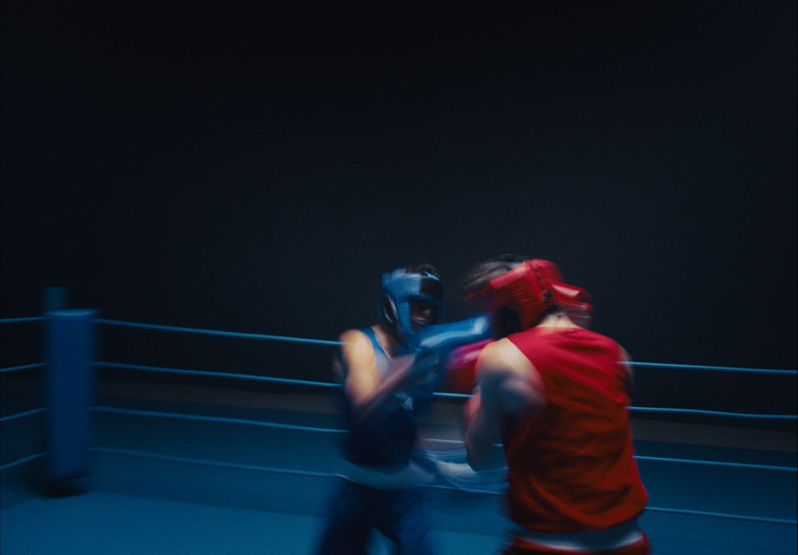 a couple of men standing next to each other in a boxing ring