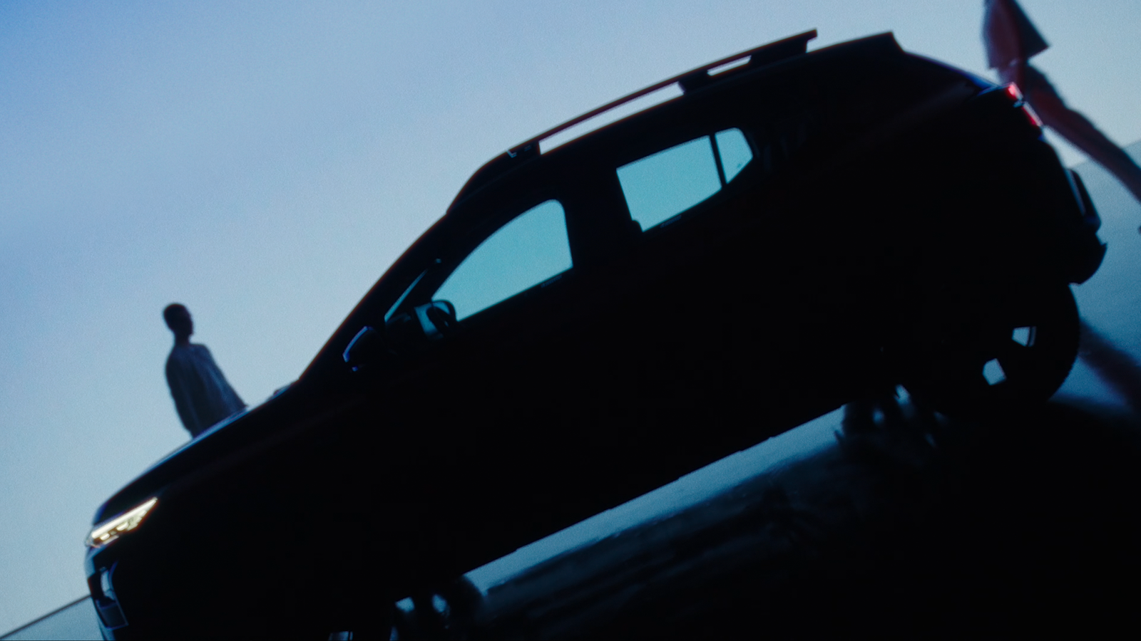 a man standing next to a black car