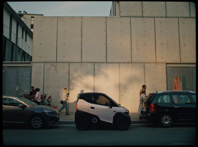 a smart car is parked on the side of the road