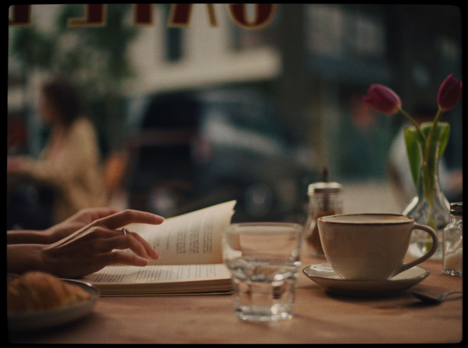 a person is reading a book at a table