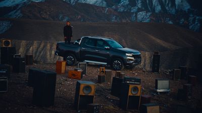 a man standing on the hood of a truck