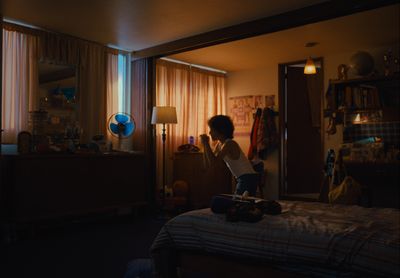 a person standing on a bed in a room