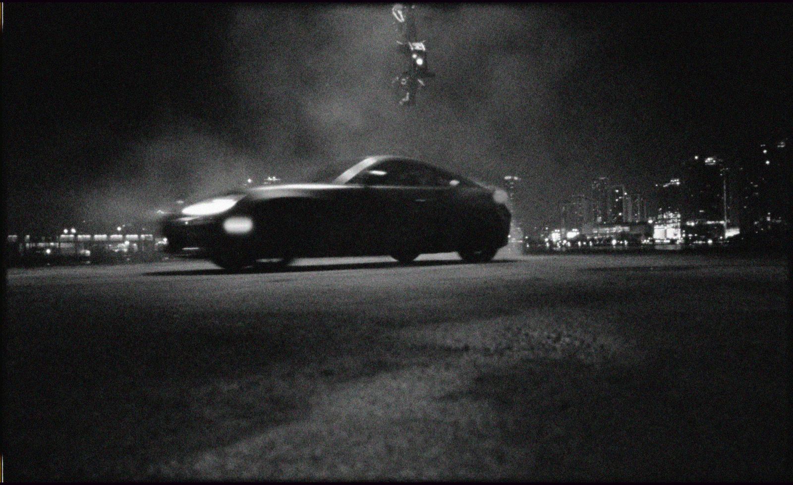 a black and white photo of a car in the dark