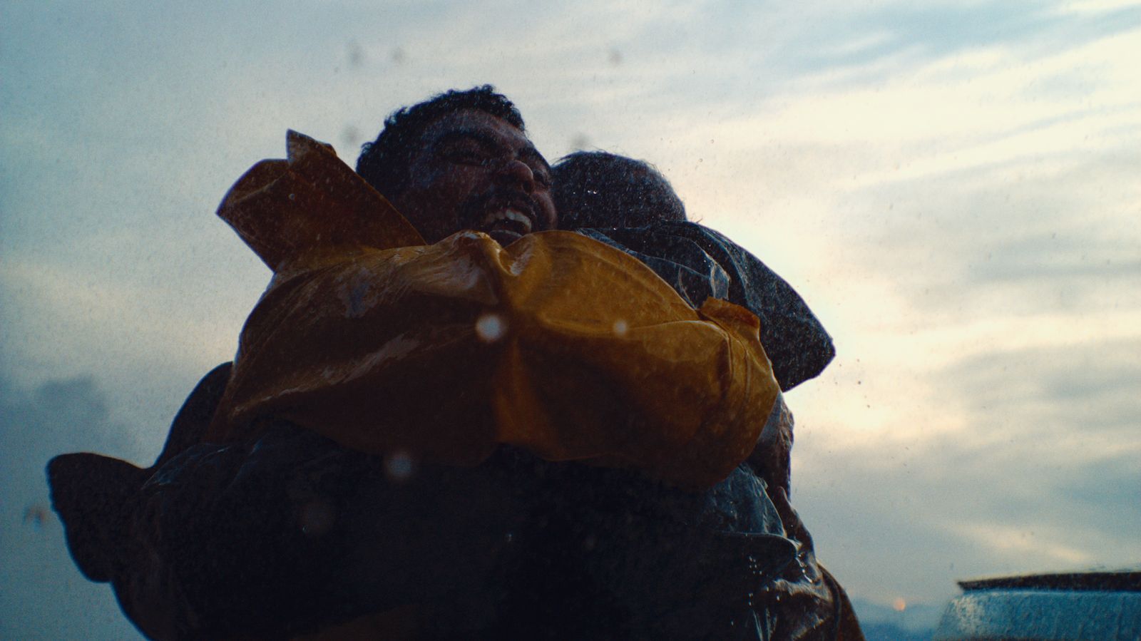 a man and a woman wrapped in a yellow jacket