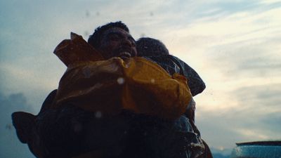 a man and a woman wrapped in a yellow jacket