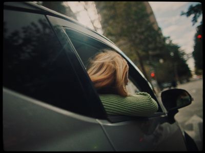 a woman leaning out of a car window