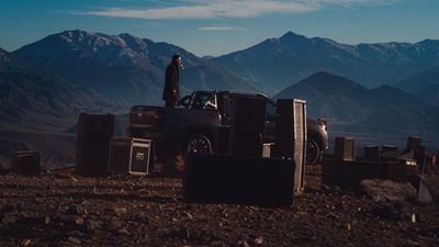 a truck parked on top of a dirt field