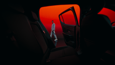 a man is standing in the back seat of a car