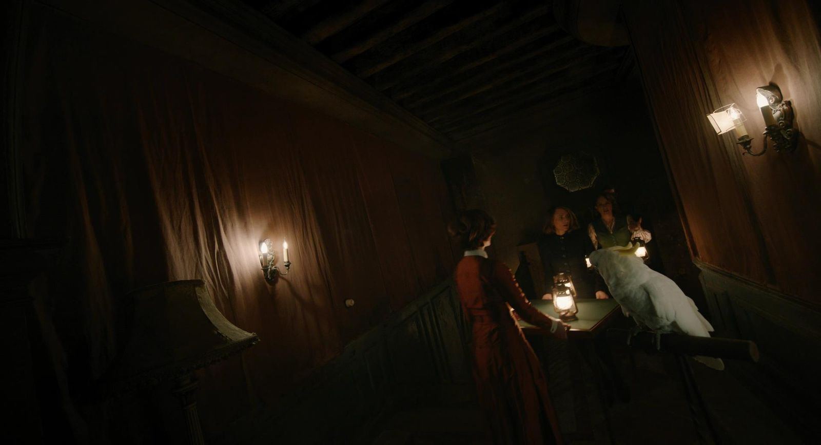 a group of people standing around a table in a dark room