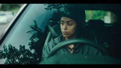 a woman sitting in the passenger seat of a car