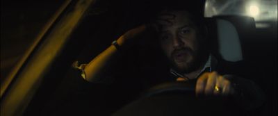 a man driving a car in the dark