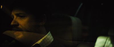 a man sitting in a car at night