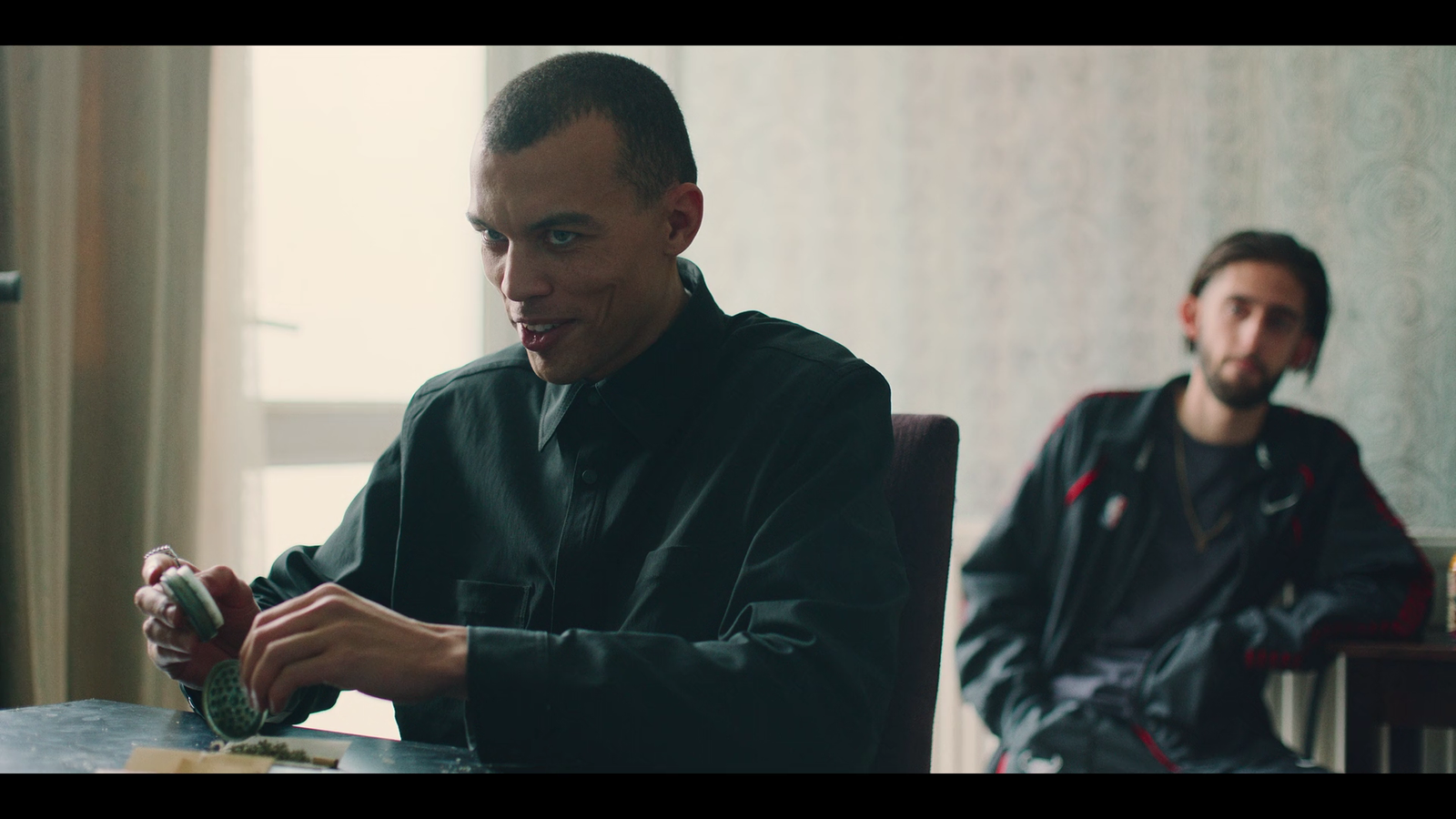 two men sitting at a table in a room